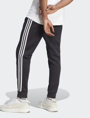 adidas Sportswear - ESSENTIALS FLEECE TAPERED CUFF 3-STRIPES PANTS - pants - black/white - 3