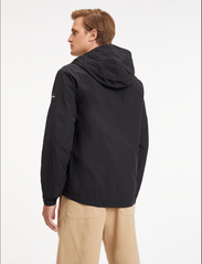 Calvin Klein - CRINKLE NYLON  BLOUSON W. HOOD - spring jackets - ck black - 4