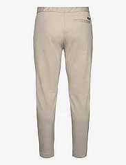Calvin Klein - COMFORT KNIT TAPERED PANT - casual trousers - stony beige - 1