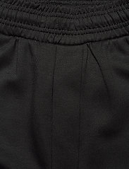 Hummel - hmlTROPPER TAPERED PANTS - sportinio tipo kelnės - black - 4