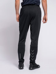 Hummel - hmlASTON TAPERED PANTS - sports pants - black - 4