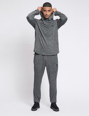 Hummel - hmlASTON TAPERED PANTS - sports pants - dark grey melange - 3