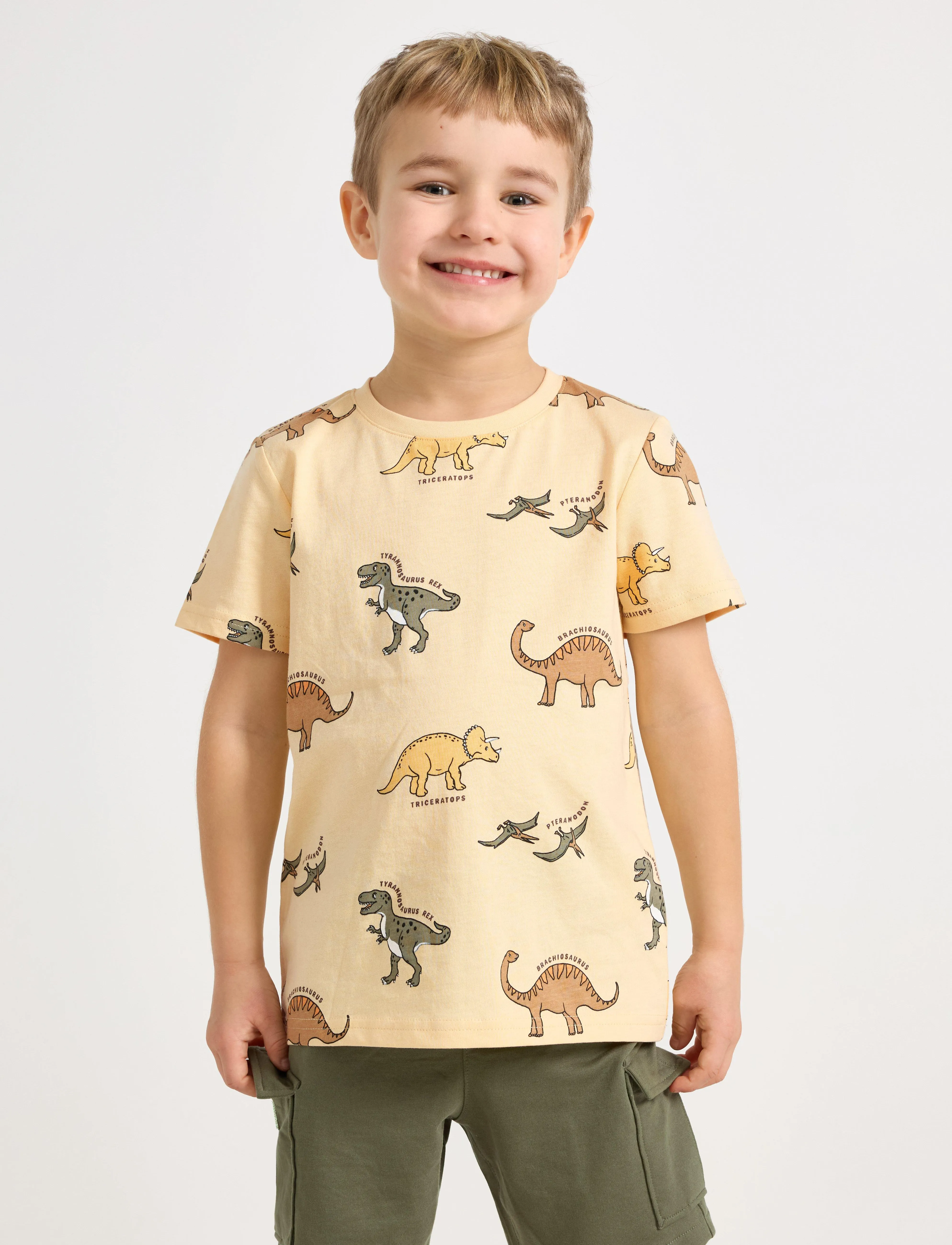 Lindex Top SS Dinos AOP - Oberteile & T-Shirts - LIGHT DUSTY YELLOW / multi